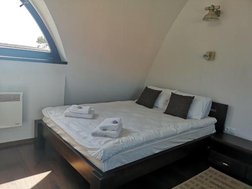 a bed with two towels on it in a room at Hunnia - Huntanya in Vlăhiţa