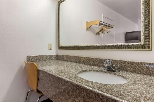 a bathroom with a sink and a mirror at Motel 6-Atlanta, TX in Atlanta