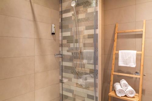a shower with a glass door in a bathroom at Best Western Plus Antibes Riviera in Antibes