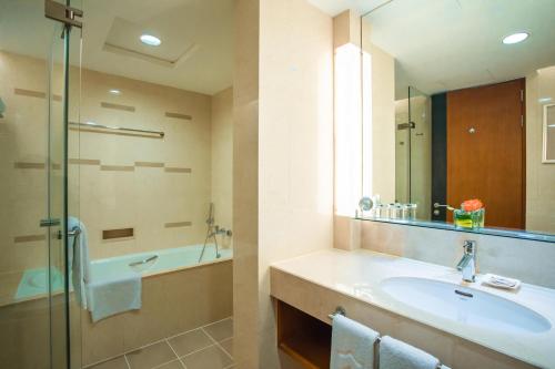 a bathroom with a sink and a shower at Shangri-La Baotou in Baotou