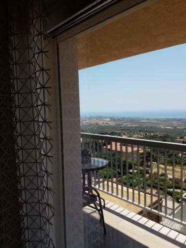 a balcony with a table and a view at Hedoné Design Experience B&B in Agrigento