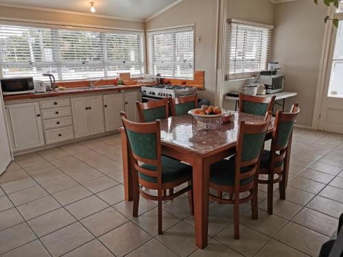 a kitchen with a table with a bowl of fruit on it at Regent Residential Villa in Whangarei
