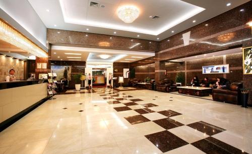 a lobby with a checkered floor in a hotel at Sunjin Grand Hotel in Ulaanbaatar