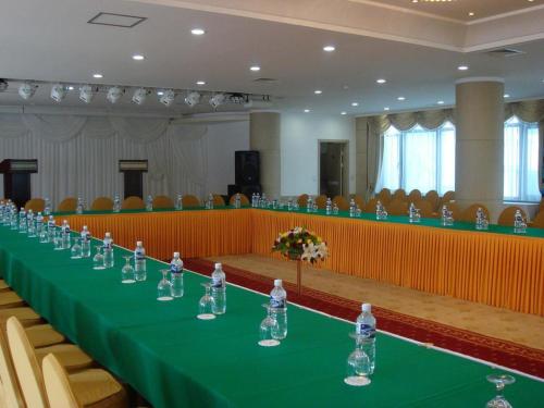 a long table in a large room with chairs at Sunjin Grand Hotel in Ulaanbaatar