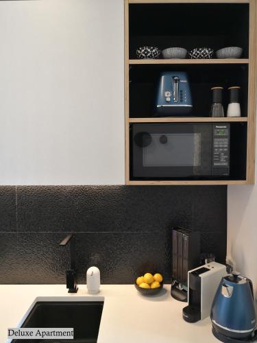 a kitchen with a counter top with a microwave at Private apartments in a Landmark Heritage Building in Auckland