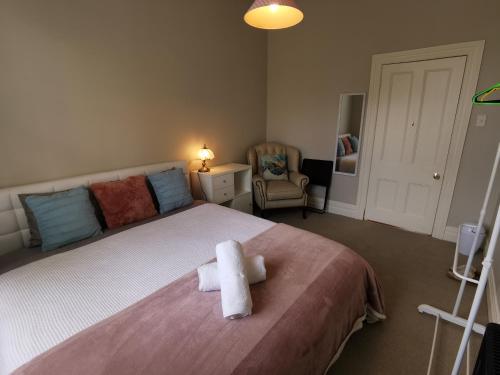 a bedroom with a bed with a towel on it at Regent Residential Villa in Whangarei