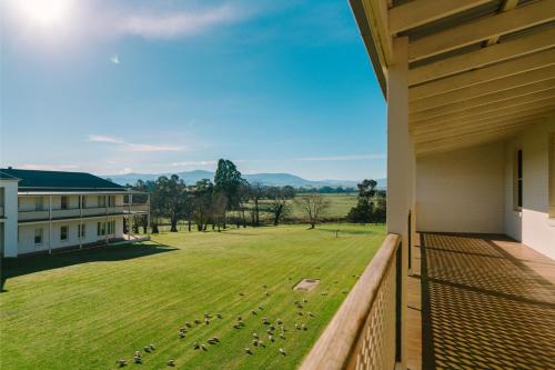 a view from the balcony of a building with a yard at Chateau Yering in Yarra Glen