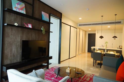 a living room with a fireplace and a dining room at Tropicana Residence KLCC @ Getaway Home Suite in Kuala Lumpur