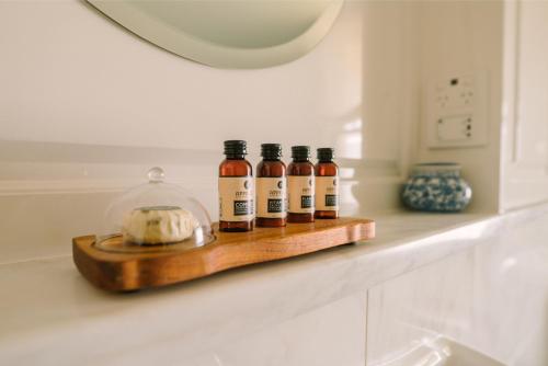 a shelf with four bottles of alcohol on a counter at Chateau Yering in Yarra Glen