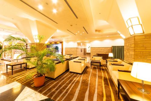 a lobby of a restaurant with tables and chairs at Hotel Terrace The Square Hitachi in Hitachi