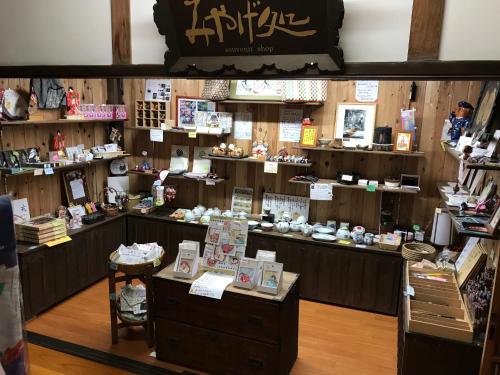 a store with a counter with books and other items at Temple Lodging Shukubo Kakurinbo in Minobu