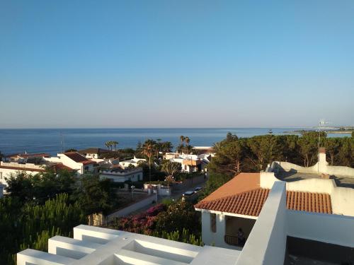 a view of a house with the ocean in the background at VILLA VEGA in Fontane Bianche