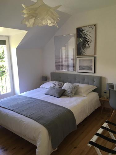 a bedroom with a large bed and a chandelier at Au bord de l'eau in La Canourgue