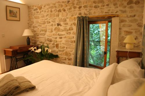 Un pat sau paturi într-o cameră la Gîte Le Gré