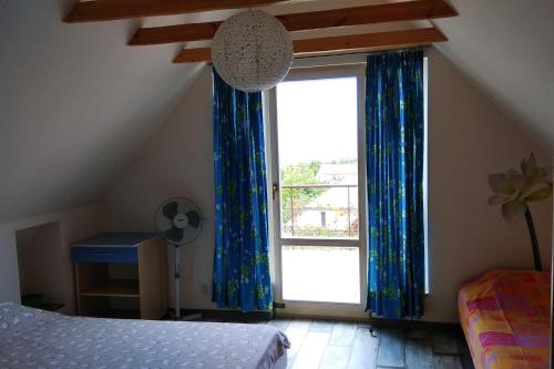 a bedroom with a bed and a large window at Vacation house in Chornomorsk