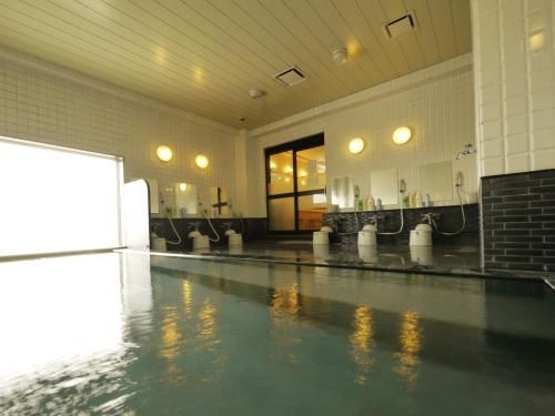 an empty swimming pool with ailed floor in a building at Hotel Route-Inn Fukaya Ekimae in Fukaya