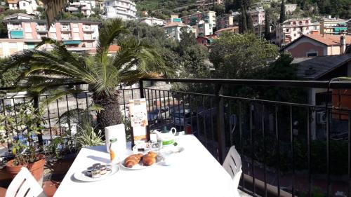 a table with food on top of a balcony at Da ö Vittorio SRL in Recco