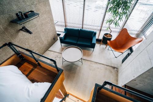 an overhead view of a room with a bed and chairs at ZONK HOTEL Nakasu-Deaibashi in Fukuoka