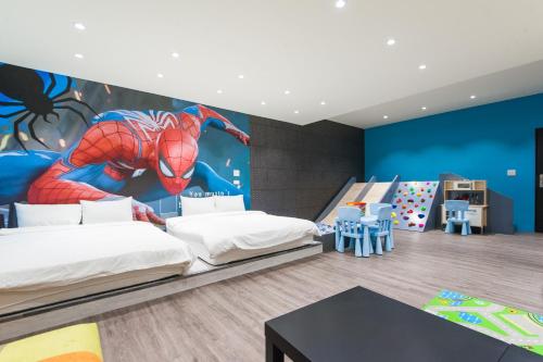 a bedroom with two beds and a spider man mural at Phoebe Trains in Luodong