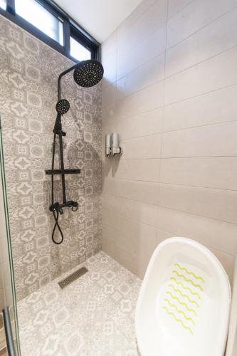 a bathroom with a shower with a toilet at Phoebe Trains in Luodong