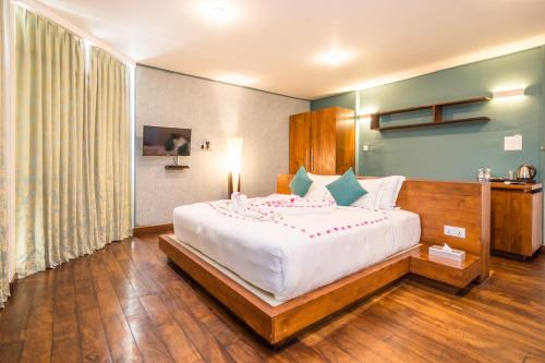 a bedroom with a large white bed in a room at Viyana Boutique Hotel in Kandy
