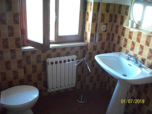 a bathroom with a toilet and a sink at Sweet Home 2 in Montopoli in Sabina