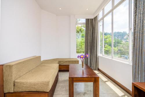 a living room with a couch and a table at Viyana Boutique Hotel in Kandy