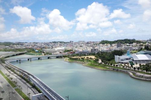 a view of a river with a bridge and a city at Terrace House Tsubokawa in Naha
