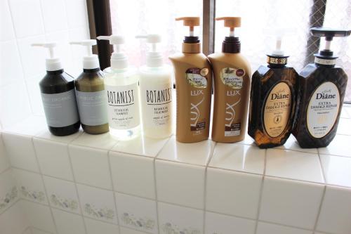 a group of bottles of hair products sitting on a counter at Terrace House Tsubokawa in Naha