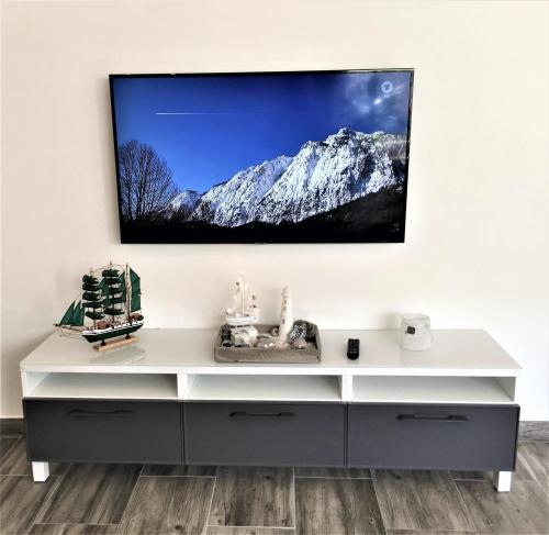 a white entertainment center with a tv on a wall at Bremen City in Bremen
