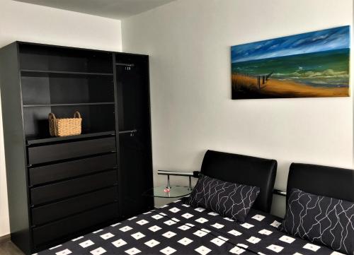 a bedroom with a bed and a painting on the wall at Bremen City in Bremen