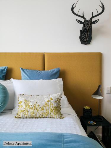 a bedroom with a bed with a deer head on the wall at Private apartments in a Landmark Heritage Building in Auckland