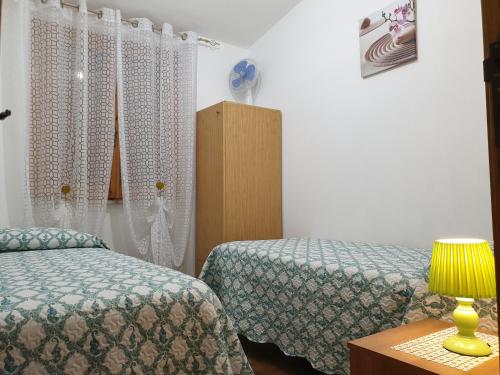 Ένα ή περισσότερα κρεβάτια σε δωμάτιο στο Casa Luciano