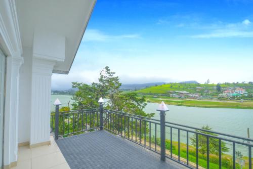 a balcony with a view of a body of water at Galaxy Grand Hotel in Nuwara Eliya