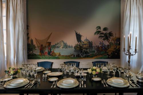 a dining room with a table with plates and silverware at Villa Saint-Ange in Aix-en-Provence