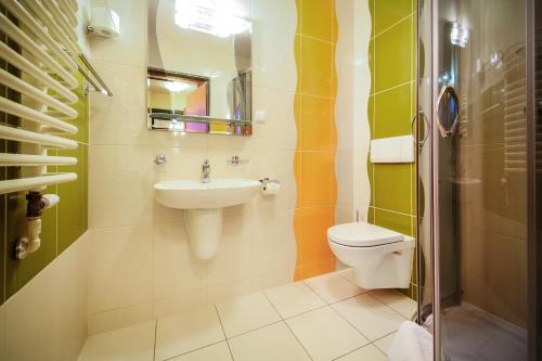 a bathroom with a sink and a toilet at Apartamenty przy Głównym Deptaku in Wisła