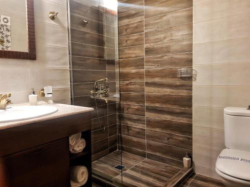 a bathroom with a shower with a toilet and a sink at Paralia Beach Boutique Hotel in Paralia Katerinis