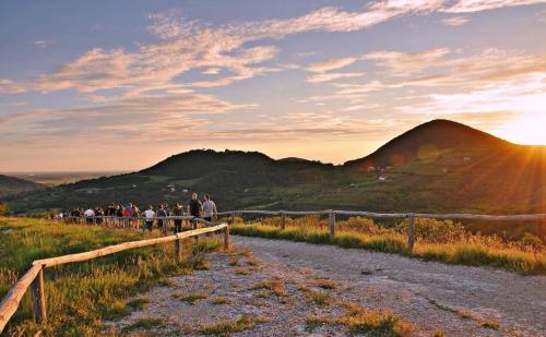 a group of people walking down a dirt road at sunset at Ca' Tobia in Teolo