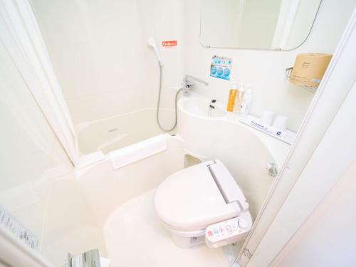 a small bathroom with a toilet and a sink at Super Hotel Kushiro-Ekimae in Kushiro