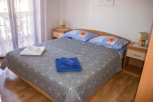 a bedroom with a bed with two towels on it at Apartments Mediterranean Sundance in Vodice