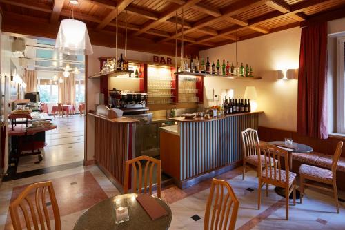 
a kitchen with a table, chairs, and a refrigerator at Hotel Villa Adriana in Monterosso al Mare
