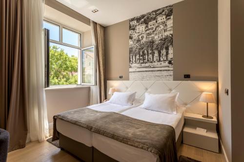 Posteľ alebo postele v izbe v ubytovaní Cornaro Hotel