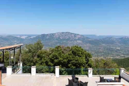 a balcony with chairs and a view of mountains at S'Enis Monte Maccione in Oliena