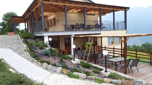 a house with a deck with tables and chairs at Agriturismo da Ysy in Civo