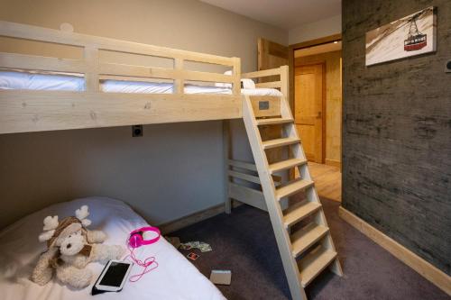 a bedroom with two bunk beds and a ladder at Résidence Daria-I Nor by les Etincelles in L'Alpe-d'Huez