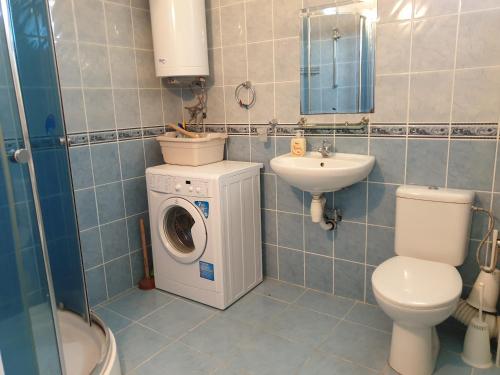 a bathroom with a washing machine and a sink at apartament Sea Star in Byala