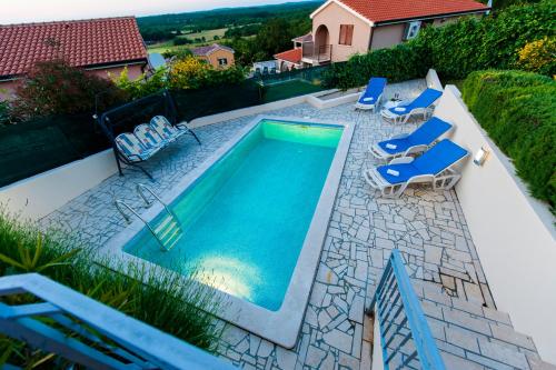 una vista aérea de una piscina con tumbonas y una piscina en Villa Istria, en Poreč