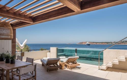 an outdoor patio with a view of the ocean at Four Seasons Astir Palace Hotel Athens in Athens