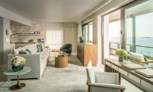 a living room with a couch and a table at Four Seasons Astir Palace Hotel Athens in Athens