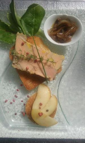 a plate with a sandwich with meat and a sauce at Hotel - Restaurant de la Paix in Barbotan-les-Thermes